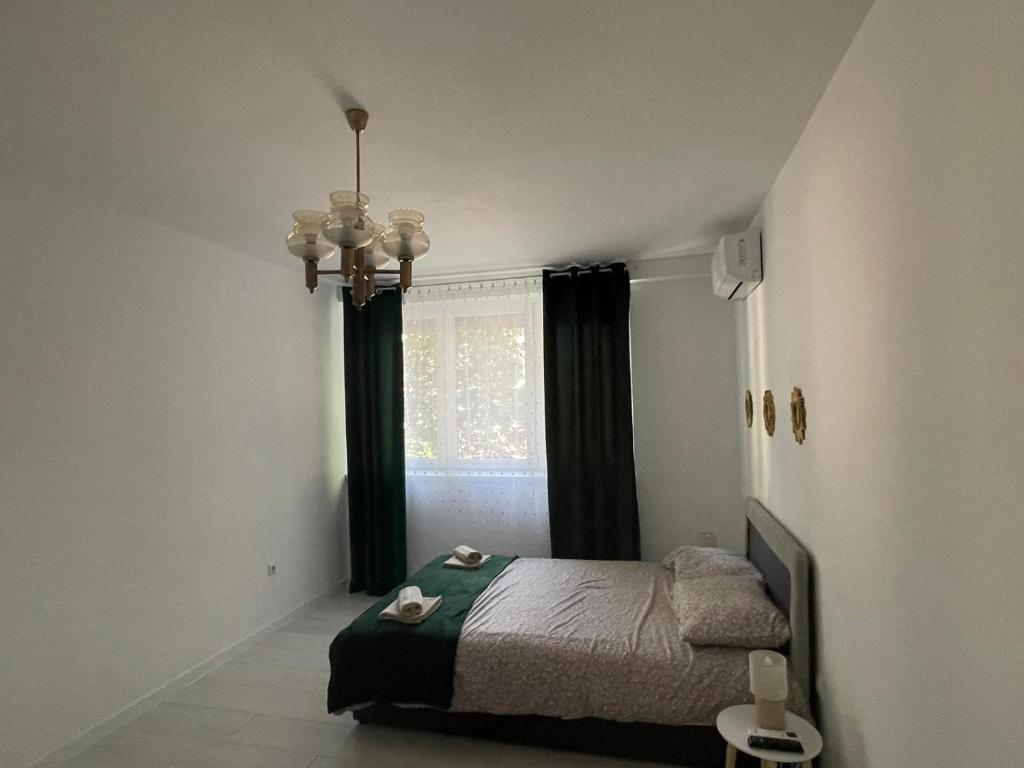 a bedroom with a bed and a window at Apartman Nikka in Bihać