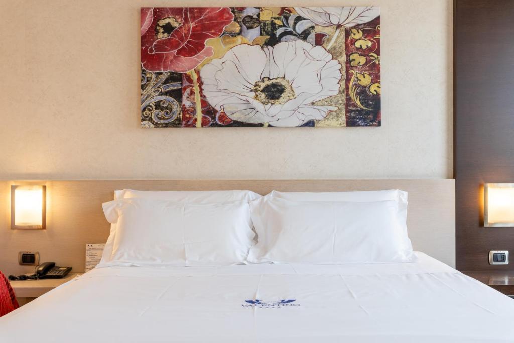 Postel nebo postele na pokoji v ubytování Hotel Valentino