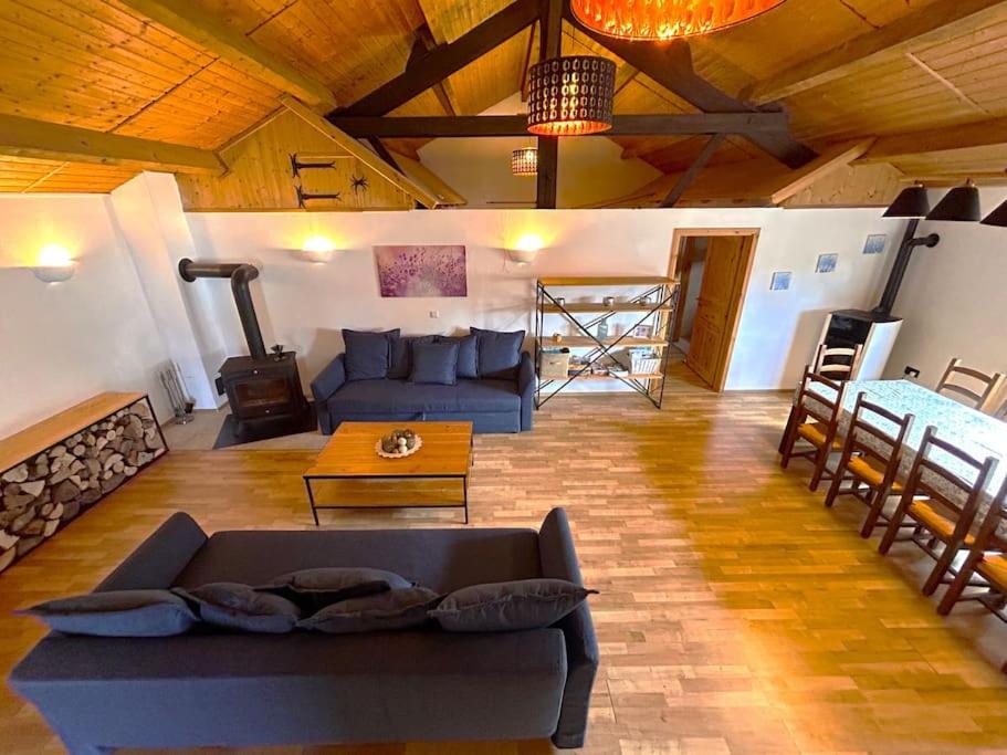 a large living room with a couch and a table at "Domaine de la Mance" - Grand gîte avec bain nordique in Vitrey-sur-Mance
