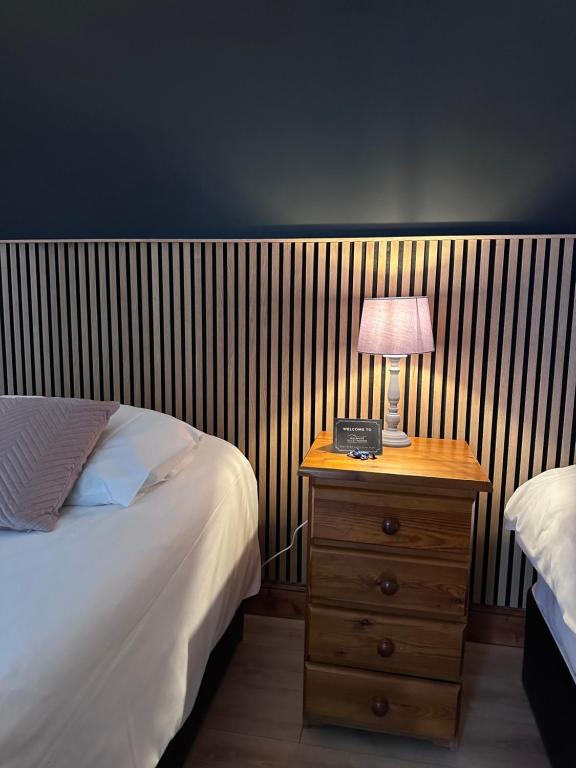 a bedroom with a bed and a night stand with a lamp at Malahide Guest Rooms in Malahide