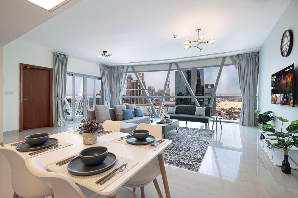 a living room with a table and a couch at DIFC Luxury 1-Bed Apt with Stunning City Views in Dubai