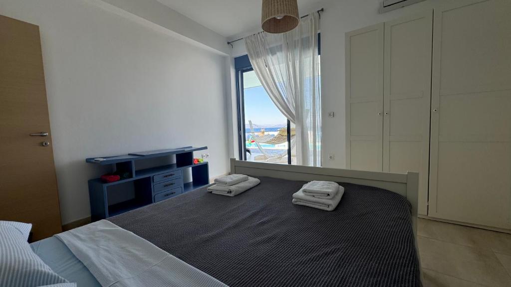 A bed or beds in a room at NV seafront Villa Aegina