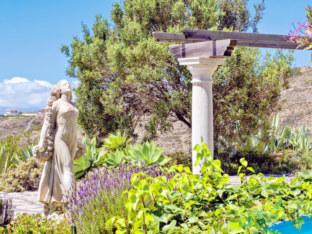 a statue of a woman in a garden at Casa Azul, Arico Viejo La Sabinita - Baden, wandern, klettern, Individualurlaub jenseits des Massentourismus, in La Sabinita