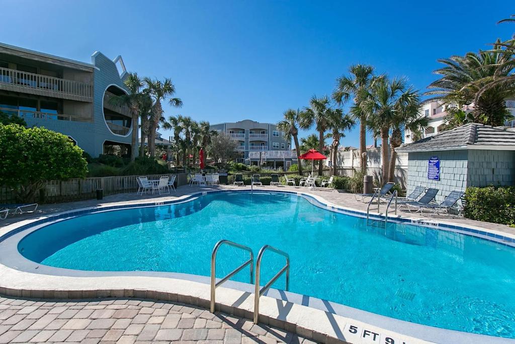 a swimming pool with blue water in a resort at Beachfront Oasis St Augustine Haven in Saint Augustine