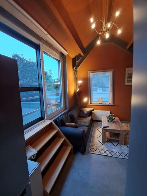 a living room with a couch and a table at L'étape Saint-Joseph in Brunehaut
