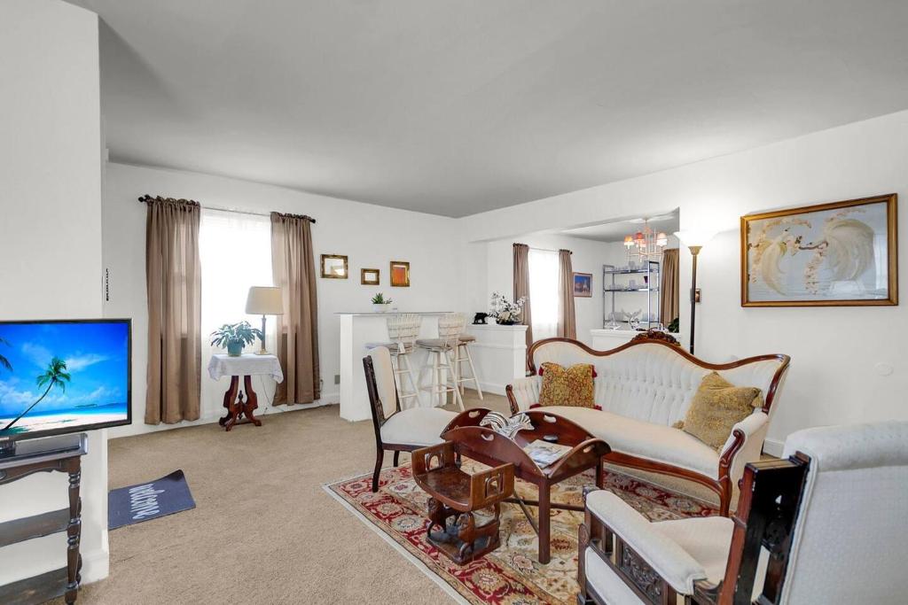 a living room with a couch and a tv at Charming Downtown Charleston, Near Hampton Park in Charleston