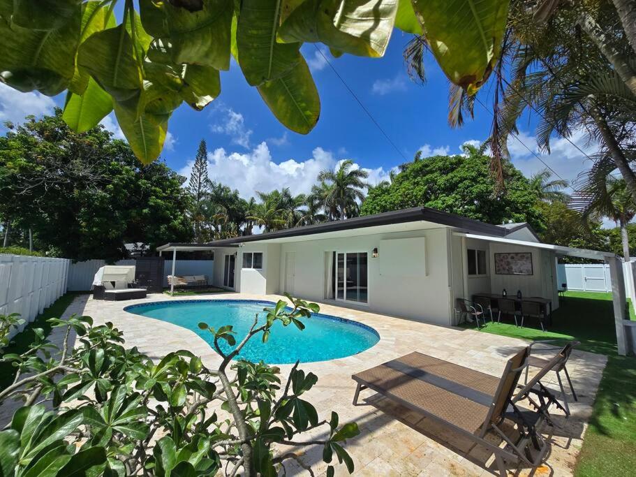 a backyard with a swimming pool and a house at Palma Haus - Modern Villa with Pool Near the Beach in Hollywood Beach