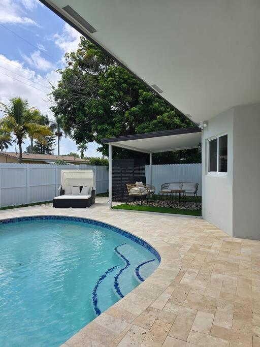a swimming pool in the backyard of a house at Palma Haus - Modern Villa with Pool Near the Beach in Hollywood Beach