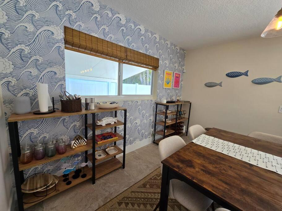 a room with a table and a blue wall at Palma Haus - Modern Villa with Pool Near the Beach in Hollywood Beach