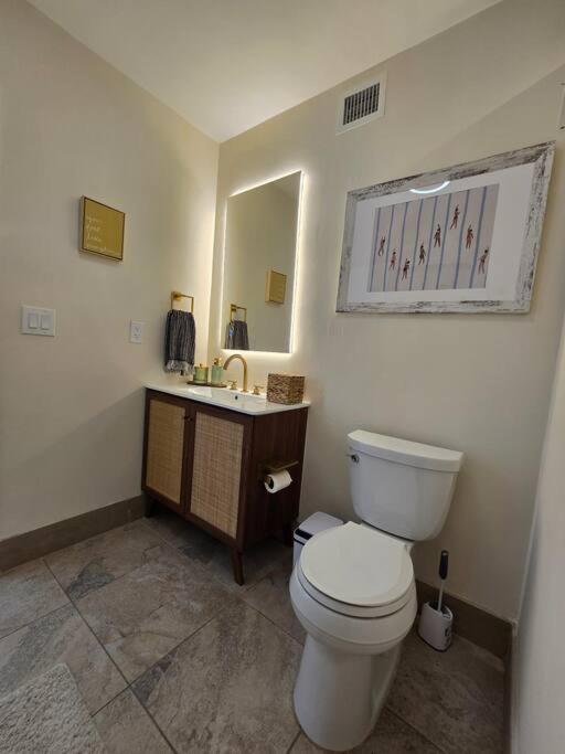 a bathroom with a white toilet and a sink at Palma Haus - Modern Villa with Pool Near the Beach in Hollywood Beach