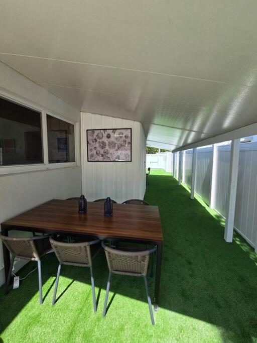 a room with a wooden table and two chairs at Palma Haus - Modern Villa with Pool Near the Beach in Hollywood Beach