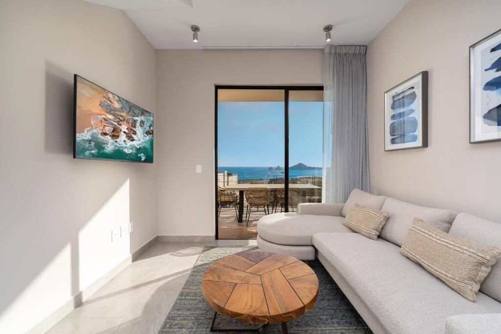 a living room with a couch and a table at Best view rooftop with heated jacuzzi in Cabo San Lucas