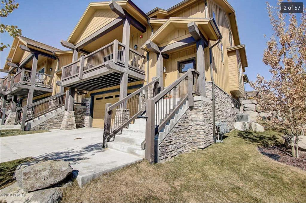 une maison avec des escaliers menant à l'avant dans l'établissement Spacious Jordanelle Retreat, Minutes to Deer Valley and Park City, Private Hot Tub, Mountain View, à Heber City