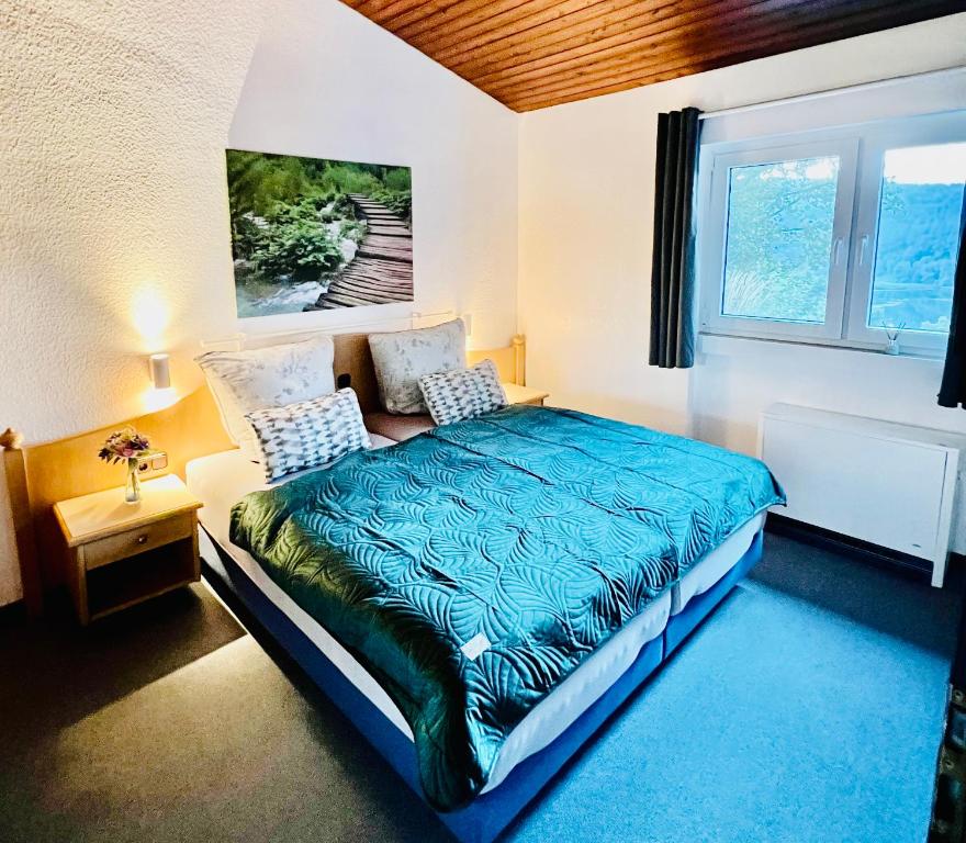 a bedroom with a bed and a window at Ferienhaus Seeblick in Biersdorf