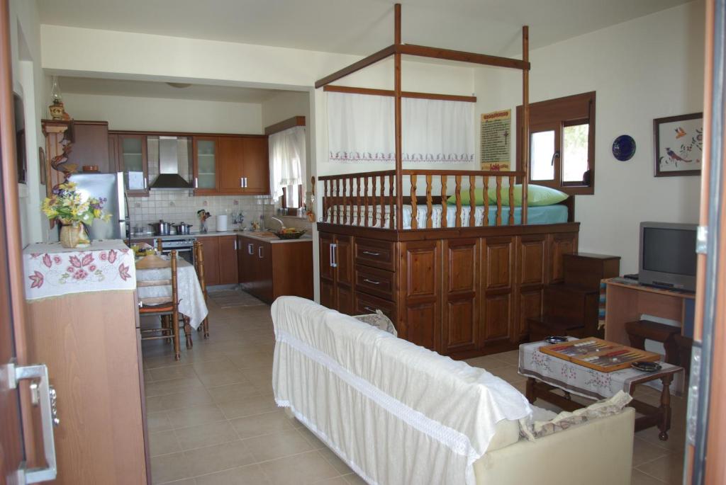 a kitchen with a couch and a table in a room at Manos House in Monólithos