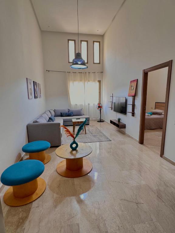 a living room with two stools and a couch at Take the Best Rest Near the airport in Nouaceur