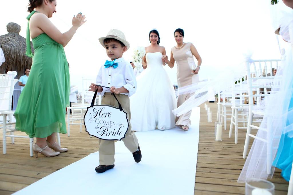 a little boy walking down the aisle at a wedding at Liberty Hotels Lara in Lara