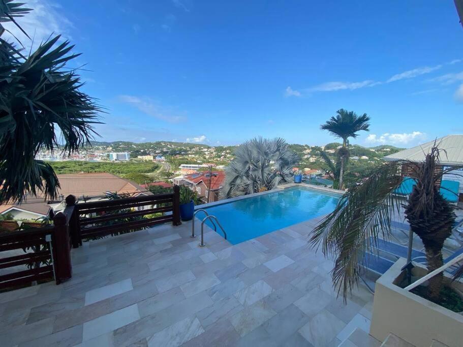 uma piscina em um resort com palmeiras em Deluxe Modern 1BR I Pool with Amazing Sea Views I Ideal Location em Gros Islet