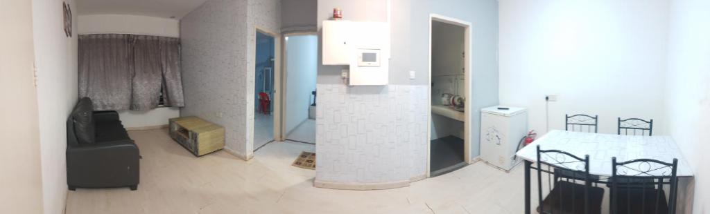 a room with a kitchen and a table in it at Santai Homestay 2 in Kota Kinabalu