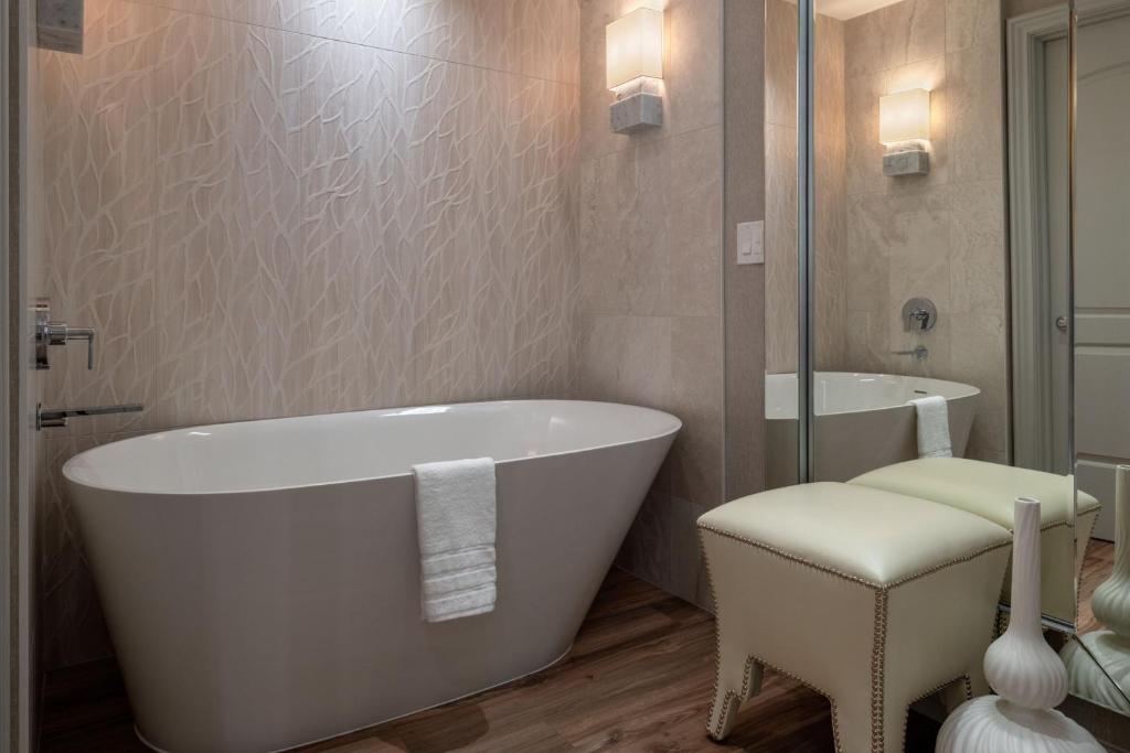 a bathroom with a white tub and a sink at The Westin Houston Downtown in Houston