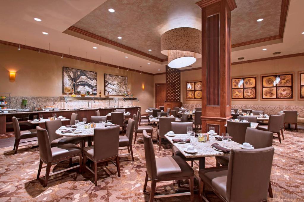 a restaurant with tables and chairs and a bar at The Westin Houston Downtown in Houston