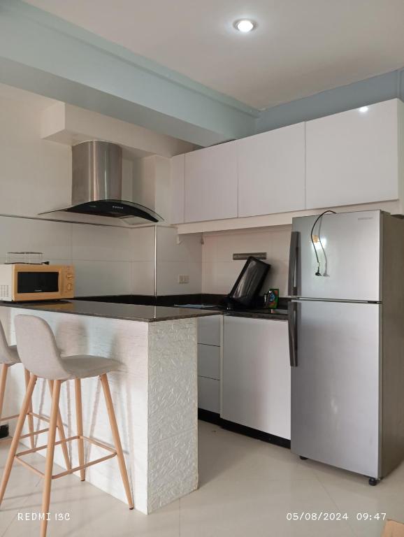 a kitchen with a counter and a refrigerator at The Loft Nook - 2 bedrooms only in Pusok
