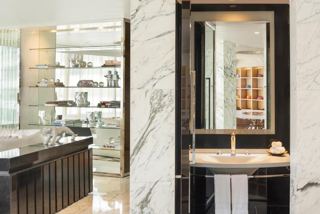 a bathroom with a sink and a mirror at W Bangkok Hotel in Bangkok
