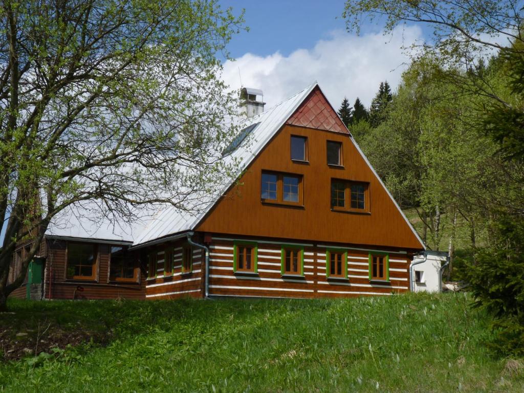 a large wooden house with a metal roof at Hepnarova Bouda in Horní Malá Úpa