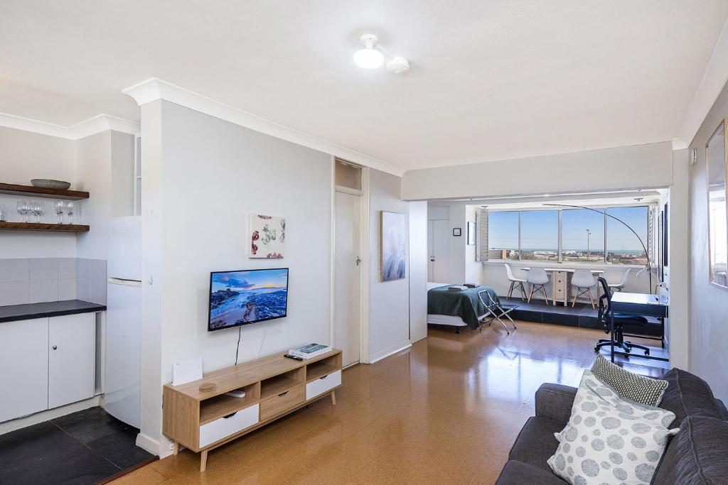 a living room with a couch and a table at Ocean Breezes in Fremantle