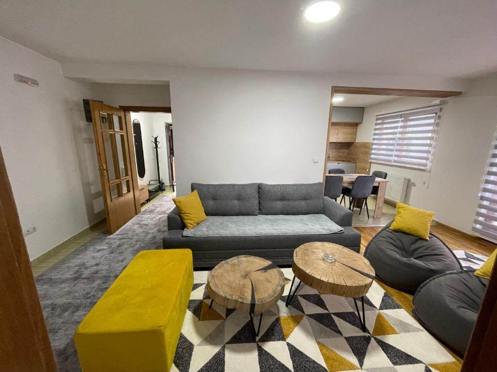 a living room with a couch and two tables at Montis Vlasic Apartment 2 in Vlasic