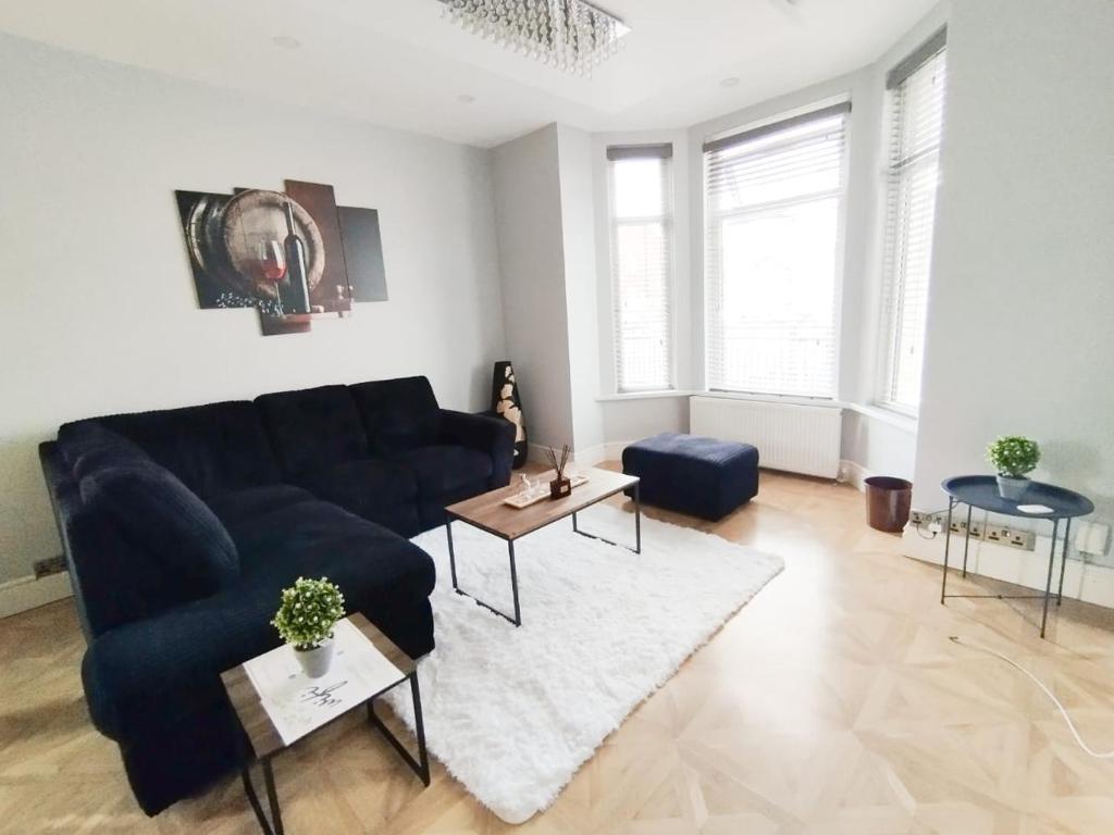 a living room with a couch and a table at Room in Stockport Road in Manchester