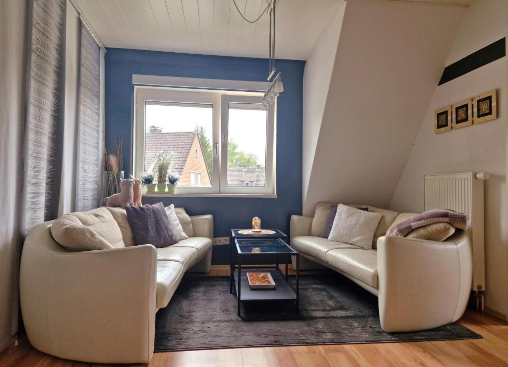 a living room with two couches and a window at Hollestübchen in Lichtenau