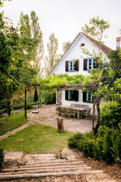 a white house with a picnic table in the yard at Landhaus Pößnitz in Leutschach