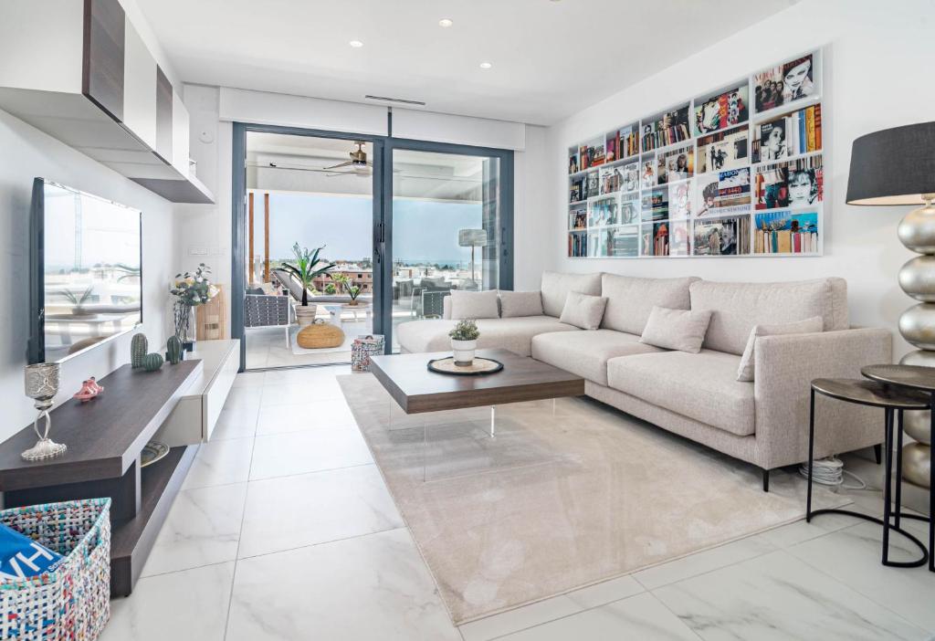 a living room with a couch and a table at LMS48- Roof terrace, jacuzzi & sauna in Estepona
