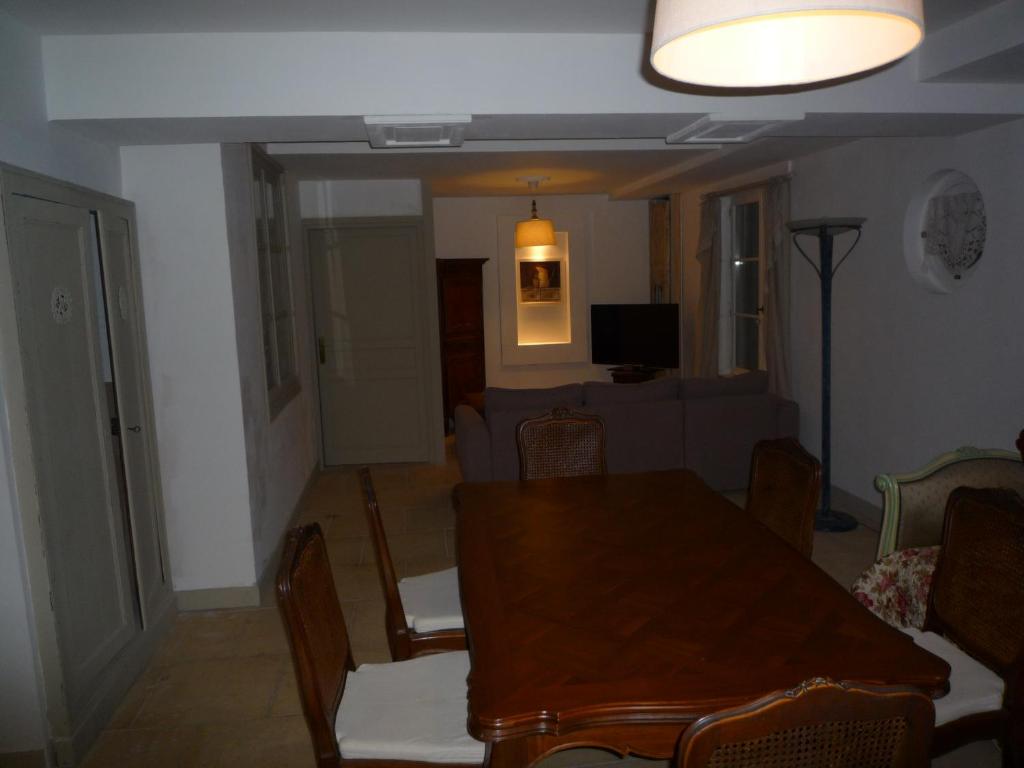 a living room with a table and a couch at Gite du Moulin des Noues in Saint-Germain-sur-École