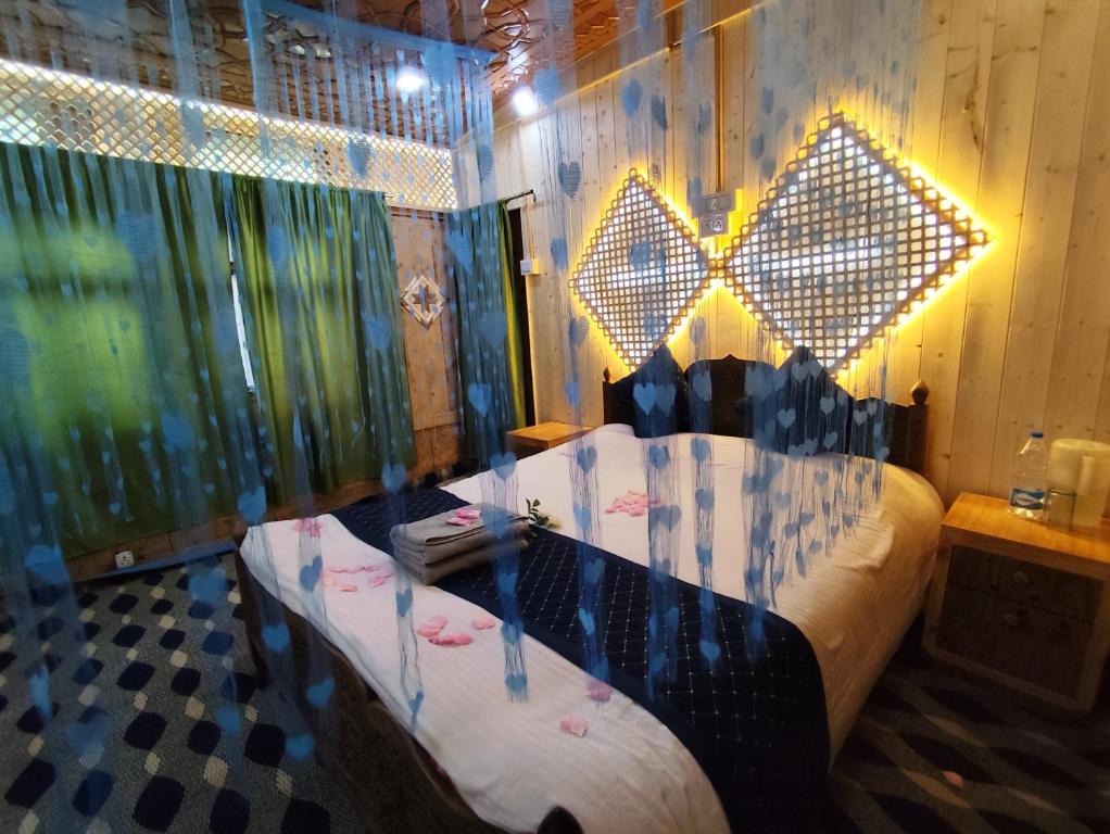 a bedroom with a large bed with lights on it at Houseboat New Shamus Maqbool in Srinagar