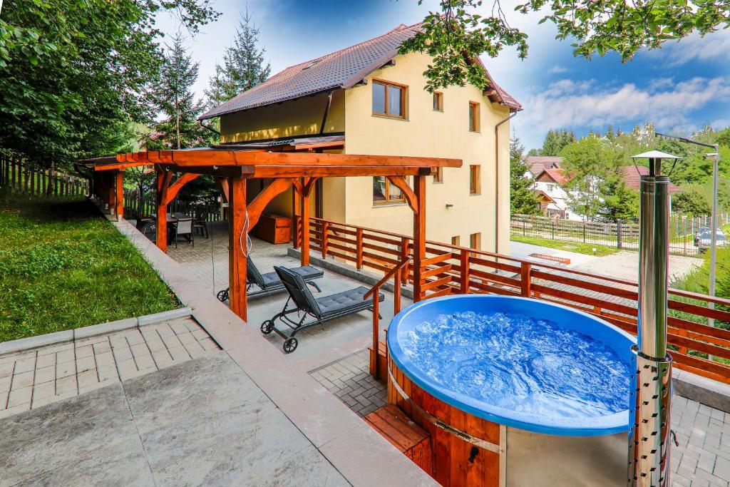 a hot tub in the backyard of a house at Cedrus Bran Boutique in Bran