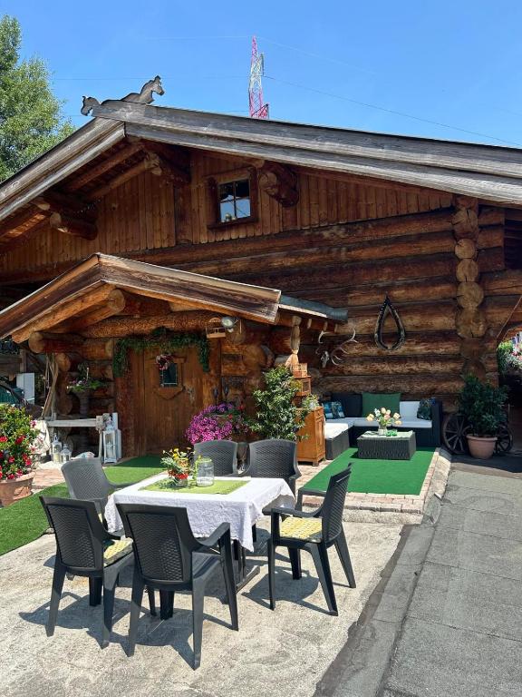 a table and chairs in front of a log cabin at Rösslwirtin Appartement in Innsbruck