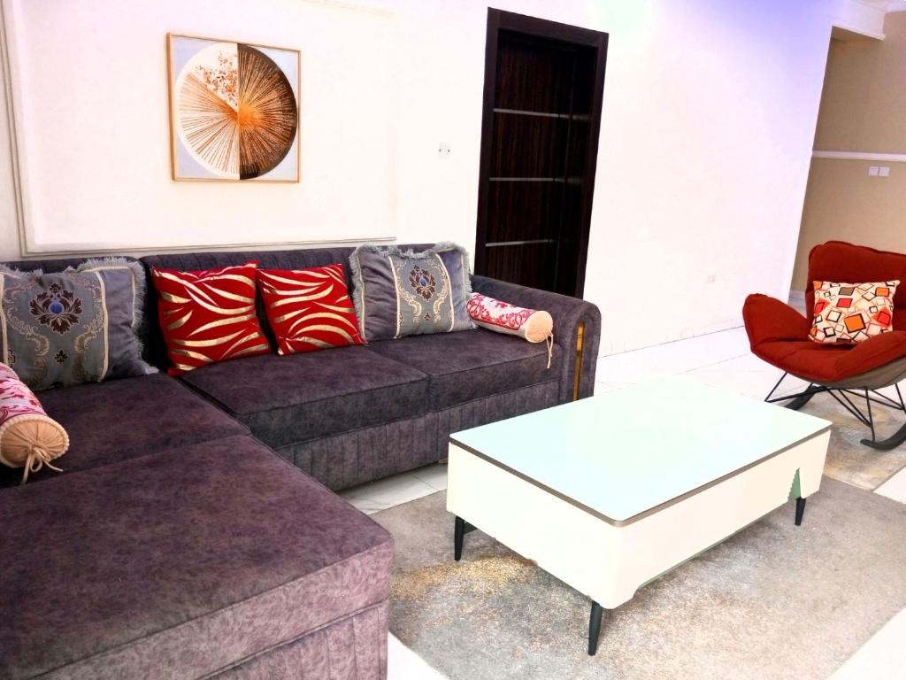 a living room with a couch and a table at The Niche Homes & Apartments in Ikoyi