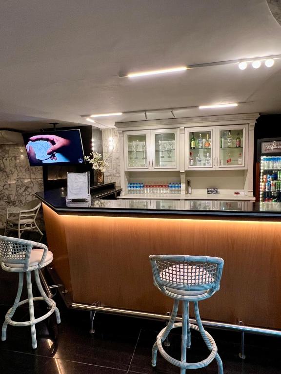 a bar in a restaurant with two stools at Hotel OK in Rio de Janeiro