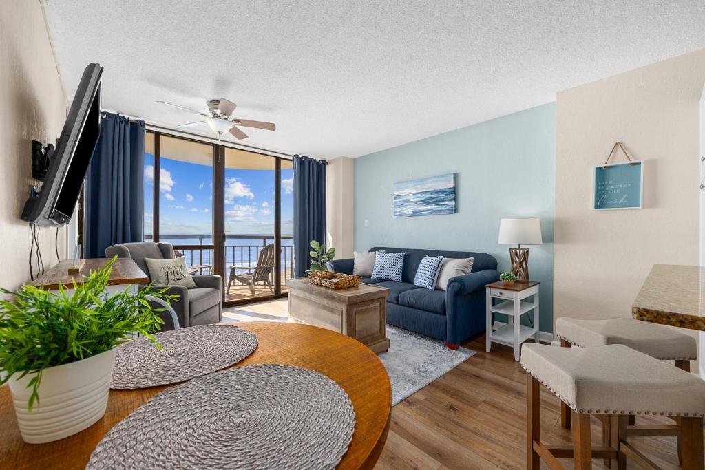 a living room with a couch and a table at Stunning 1 Bedroom Condo-Breathtaking Oceanfront Views-Meridian 602 in Myrtle Beach