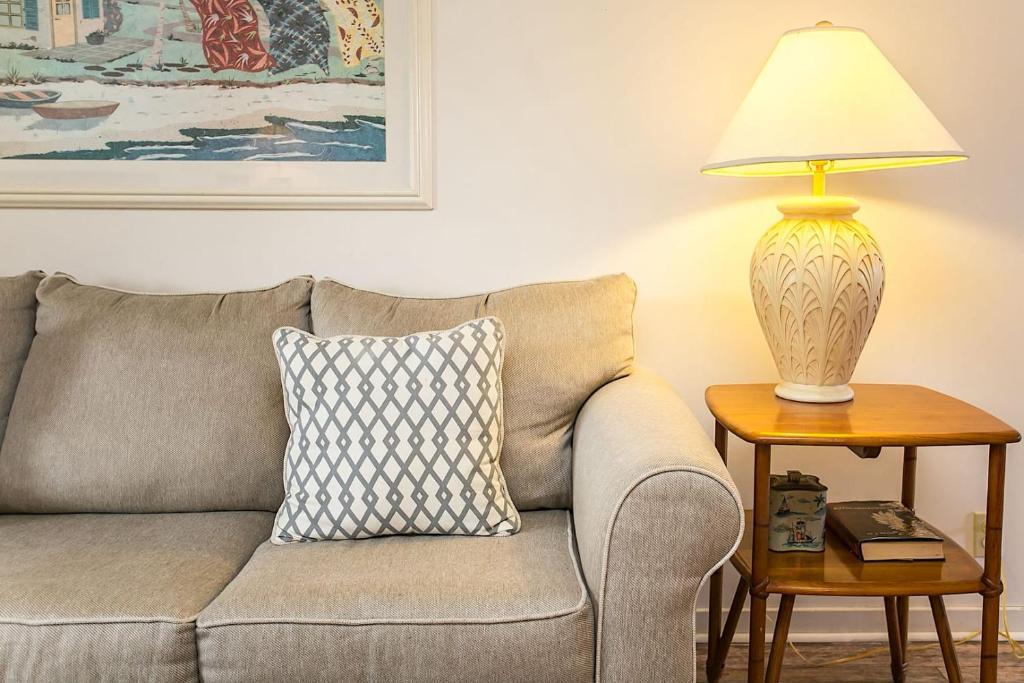 a lamp on a side table next to a couch at Hibiscus H204 in St. Augustine