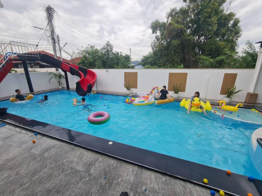 a group of people playing in an indoor swimming pool at Huahin Friends Pool Villa 1 in Hua Hin