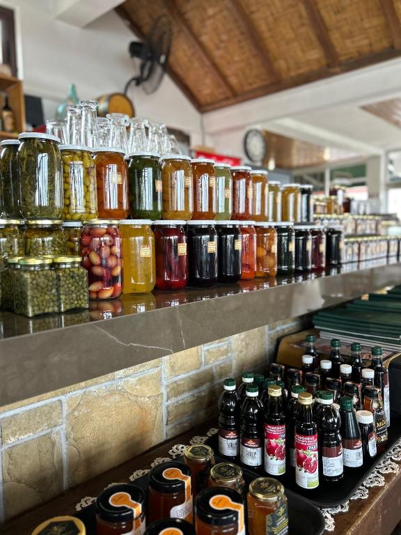 a row of bottles on a counter in a kitchen at Two Flowers Hotel in Pedoulas