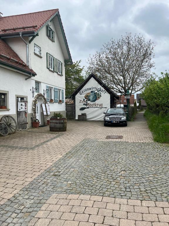 a car parked in front of a white building at Modernes 65qm Dachstudio im alten Bauernhaus - perfekt für Wandern Bikes Feiern in Erkenbrechtsweiler