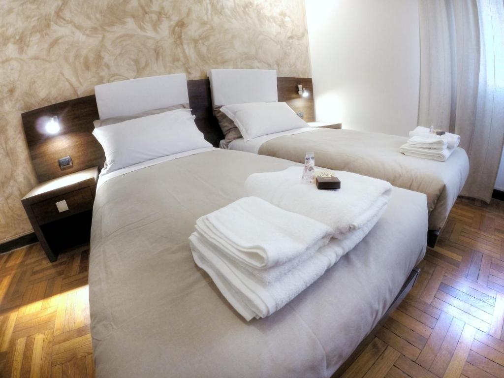Postel nebo postele na pokoji v ubytování Guesthouse Vittoria Rooms - the Original since 2015