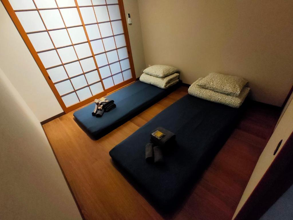 Postel nebo postele na pokoji v ubytování 豆インMaMe Inn