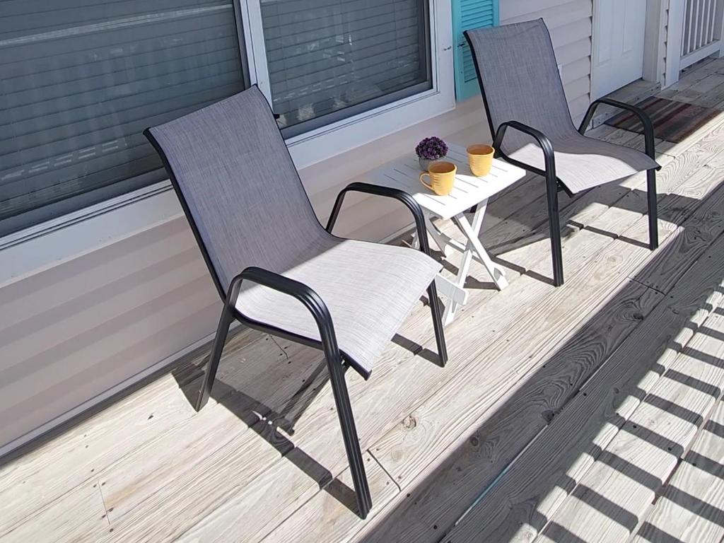zwei Stühle und ein Tisch auf einer Veranda in der Unterkunft Condo in Gulf Shores King Suite in Gulf Shores