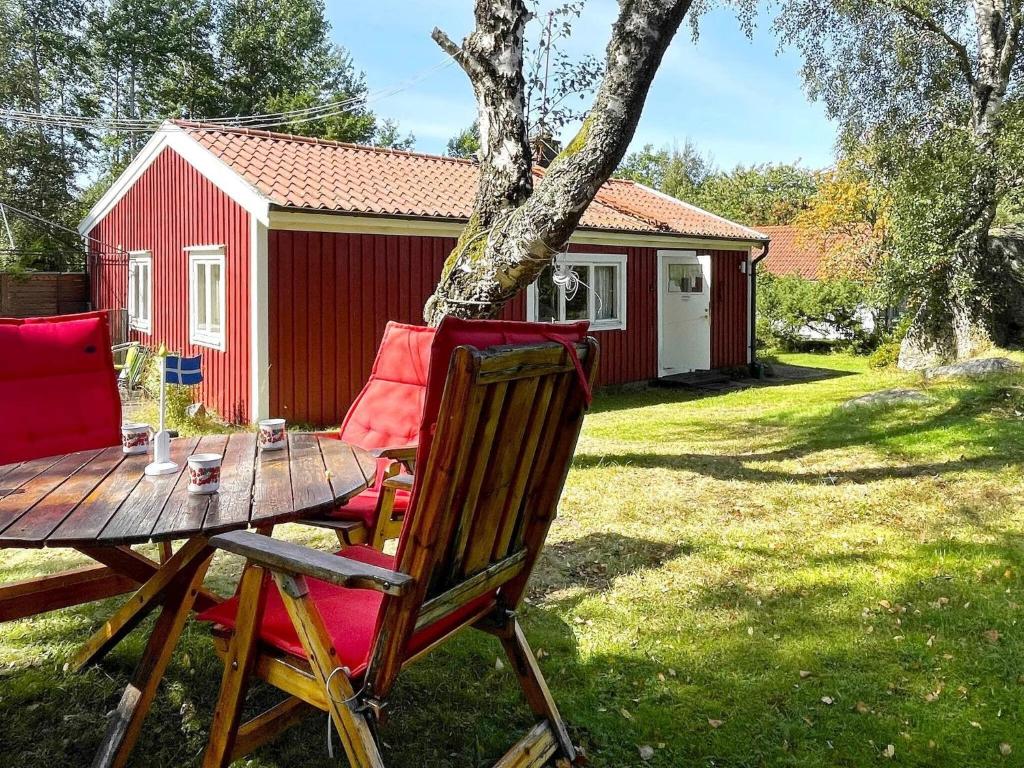 a table and two chairs in front of a cabin at 5 person holiday home in UDDEVALLA-By Traum in Lysekil