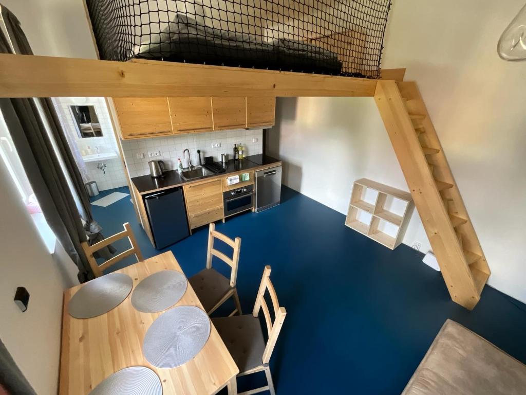 an overhead view of a kitchen with a table and chairs at Apartment FOX in Kořenov